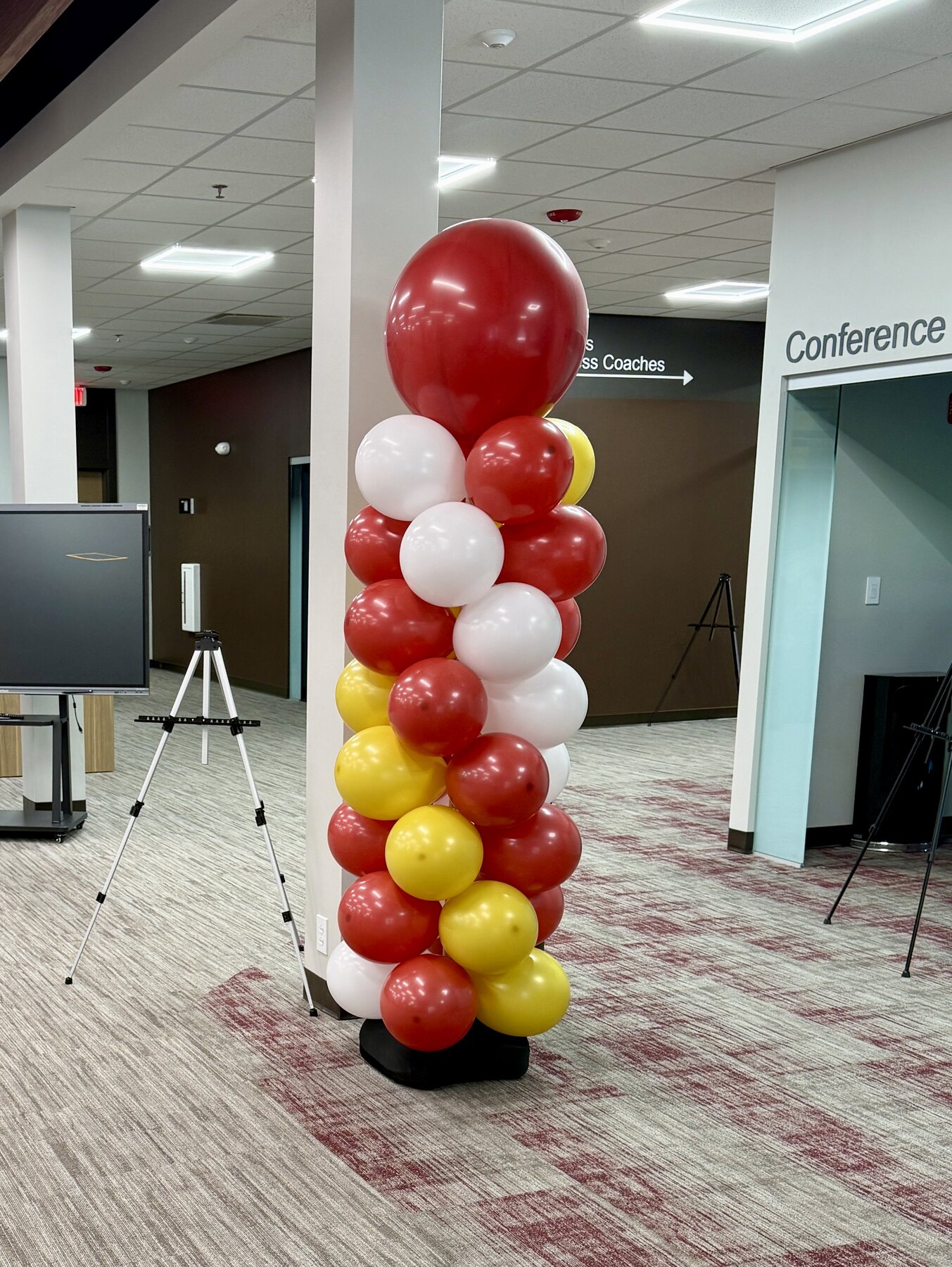 Purple, black, and gold balloon column